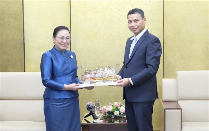 Đại sứ Đặc mệnh Toàn quyền Cộng hòa dân chủ Nhân dân Lào tại Việt Nam Khamphao Eunthavanh (bên trái) tặng quà lưu niệm đến Phó Chủ tịch Thường trực UBND thành phố Hồ Kỳ Minh. (Ảnh: 