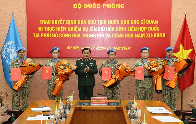 Thượng tướng Hoàng Xuân Chiến trao Quyết định của Chủ tịch nước và tặng hoa chúc mừng các sĩ quan đi thực hiện nhiệm vụ GGHB Liên hợp quốc.