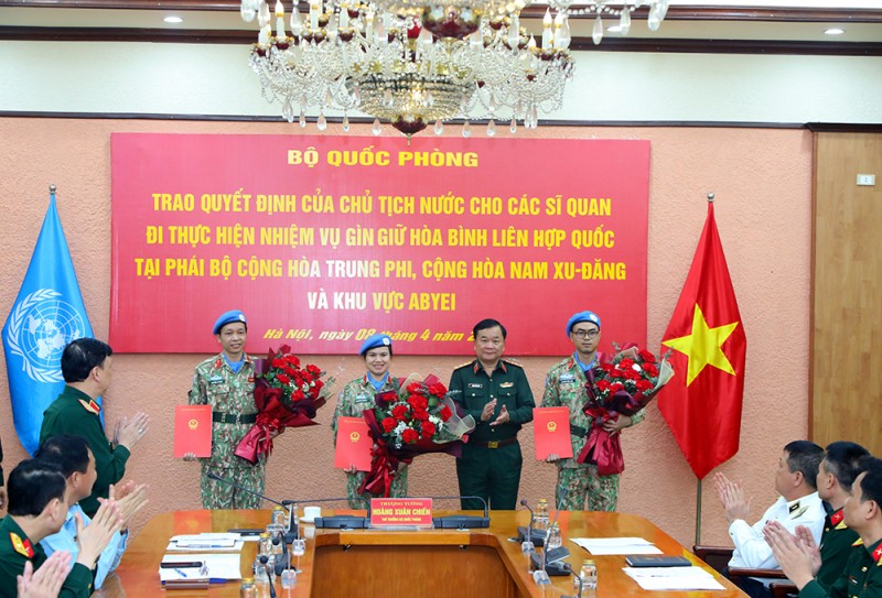 Thượng tướng Hoàng Xuân Chiến trao Quyết định của Chủ tịch nước và tặng hoa chúc mừng các sĩ quan đi thực hiện nhiệm vụ GGHB Liên hợp quốc. 