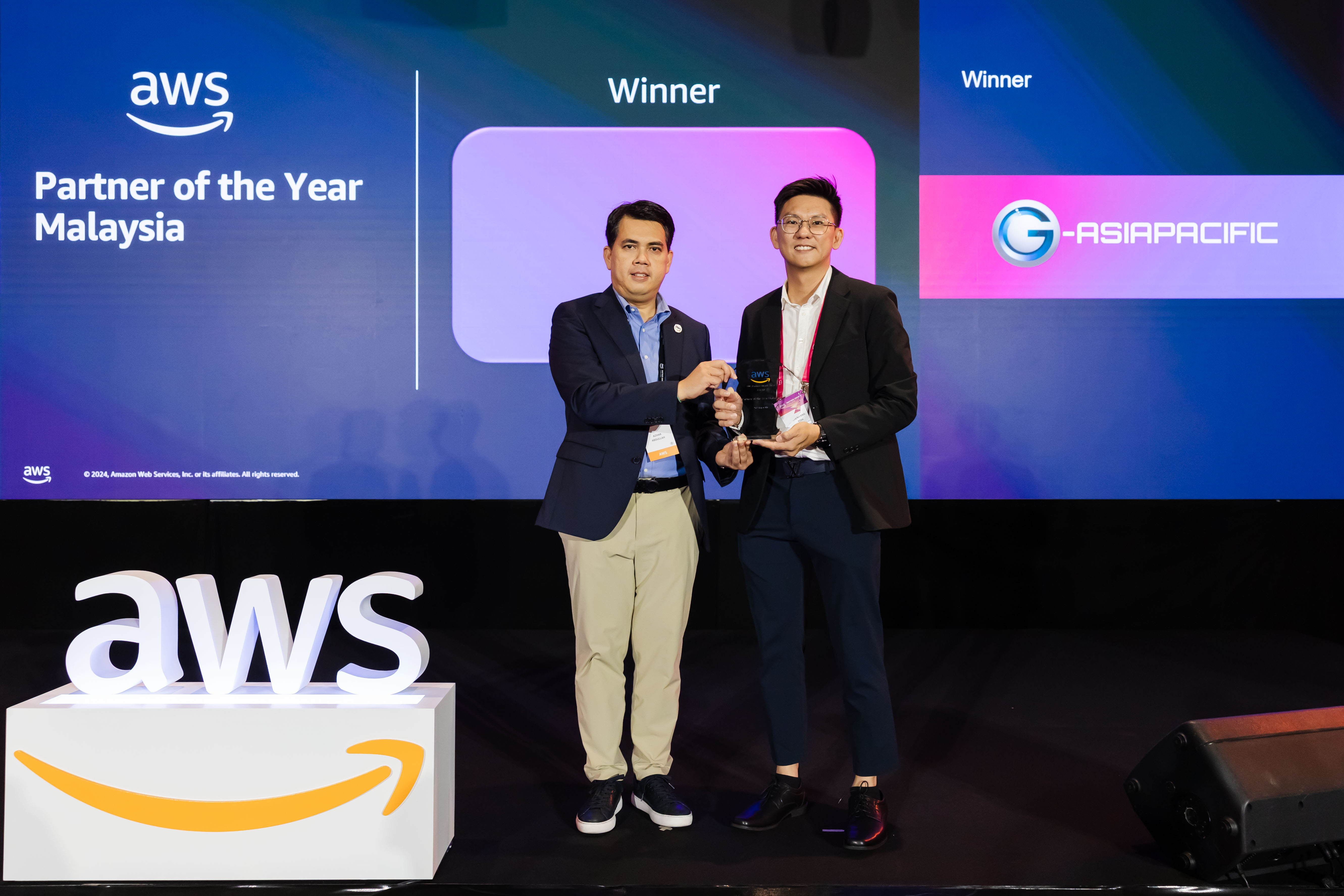 COO Toh Zhen Yang receiving the AWS Partner of the Year Malaysia 2024 award.