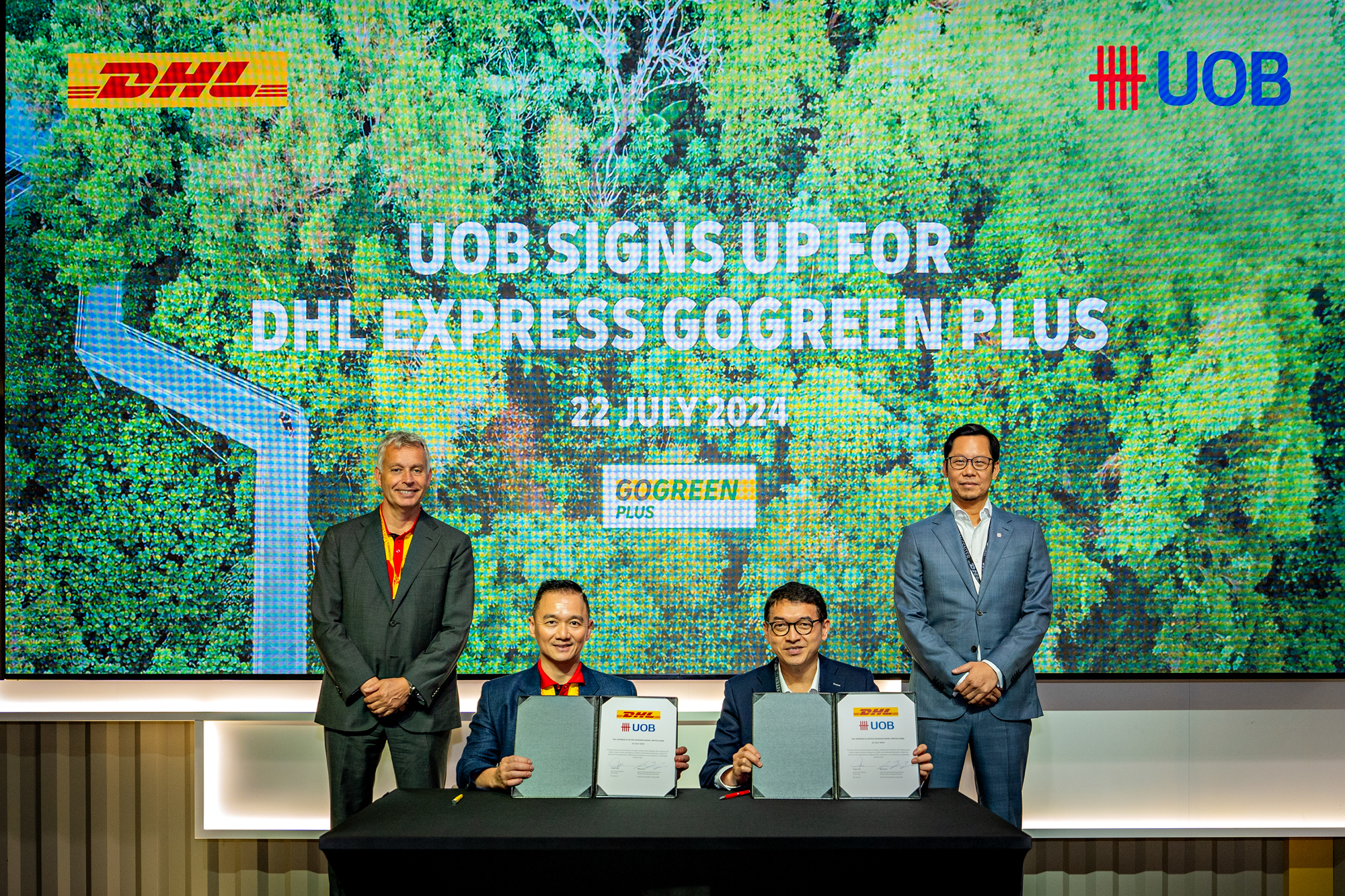 UOB has entered into a strategic agreement with DHL Express for its GoGreen Plus service to co-invest in the use of sustainable aviation fuel for the Bank's international parcel deliveries. From L to R: Michiel Greeven, EVP, Global Commercial, DHL Express; Yung C. Ooi, SVP, Commercial, Asia Pacific, DHL Express; Marcus Lai, Head of Corporate Real Estate Services, UOB; and Eric Lim, Chief Sustainability Officer, UOB, at the signing ceremony at the DHL Asia Pacific Innovation Center that took place on 22 July 2024.