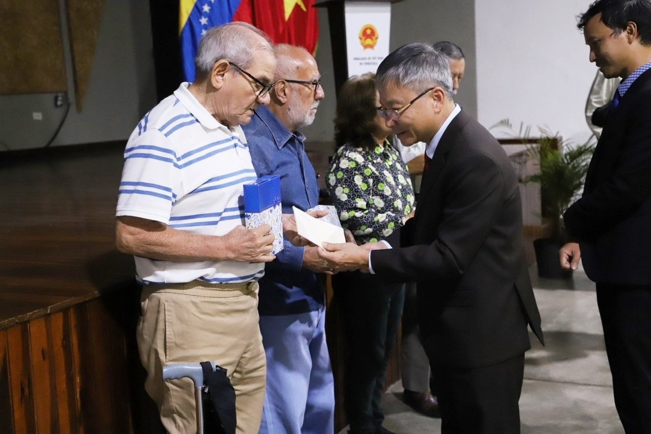 Phó Bí thư Thường trực Tỉnh ủy Quảng Nam Nguyễn Đức Dũng tặng quà cho các du kích quân Caracas. (Ảnh: Báo Quảng Nam)