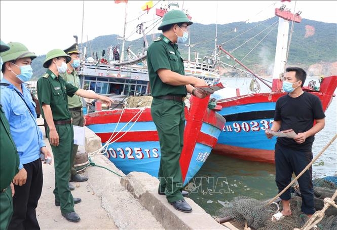 Đồn biên phòng Cửa Sót tuyên truyền bầu cử, phòng chống dịch COVID-19 cho ngư dân tại cảng cá Thạch Kim huyện Lộc Hà. Ảnh: Công Tường/TTXVN