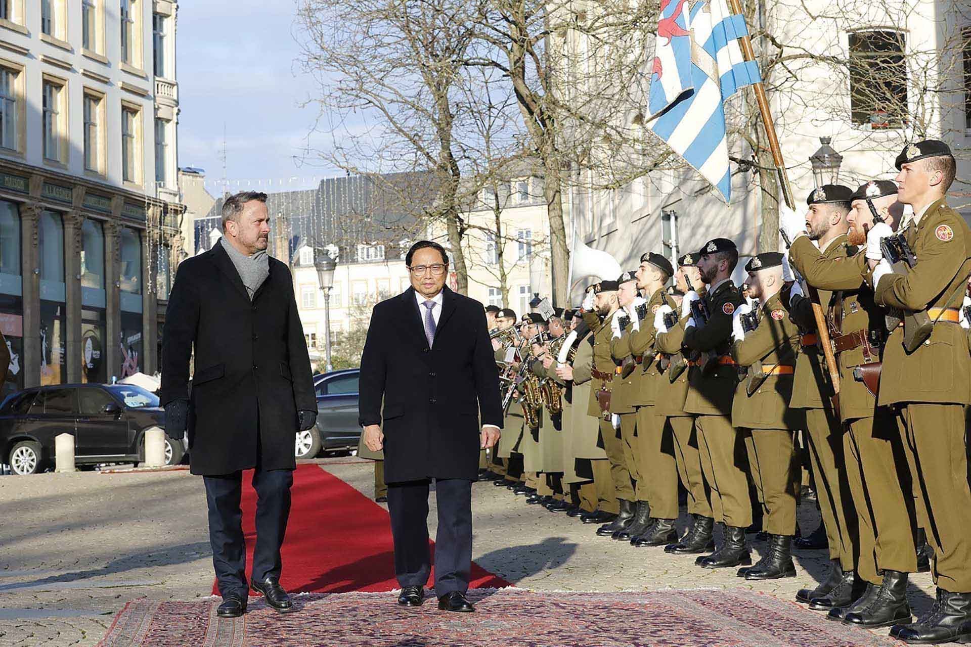 Thủ tướng Phạm Minh Chính và Thủ tướng Luxembourg Xavier Bettel duyệt đội danh dự. (Nguồn: TTXVN)