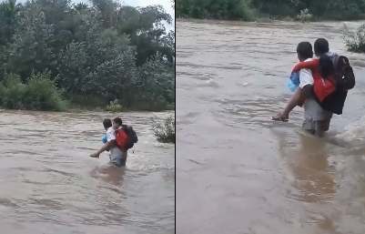 Xúc động clip cha cõng con gái băng qua dòng lũ dữ để tới trường