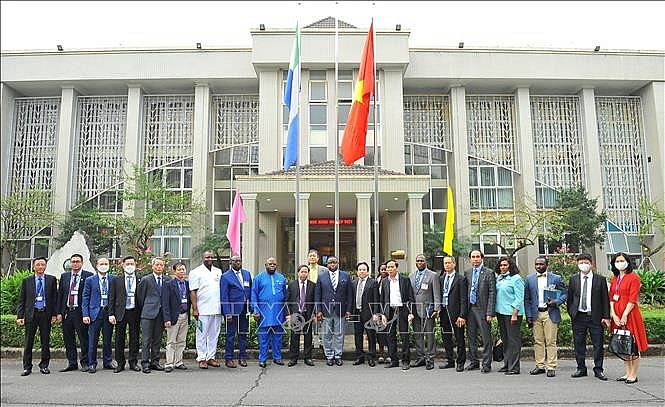 Tổng thống Julius Maada Bio cùng Đoàn đại biểu chụp ảnh lưu niệm với cán bộ nhân viên Viện Khoa học Nông nghiệp Việt Nam. Ảnh: Minh Đức/TTXVN