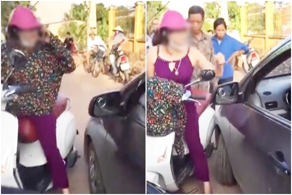 nguoi phu nu coi ao chui lai xe o to nhu tat nuoc roi xong vao danh nhau vi bi nhac nho khi dung giua duong nghe dien thoai