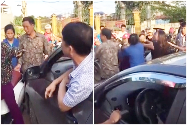 nguoi phu nu coi ao chui lai xe o to nhu tat nuoc roi xong vao danh nhau vi bi nhac nho khi dung giua duong nghe dien thoai